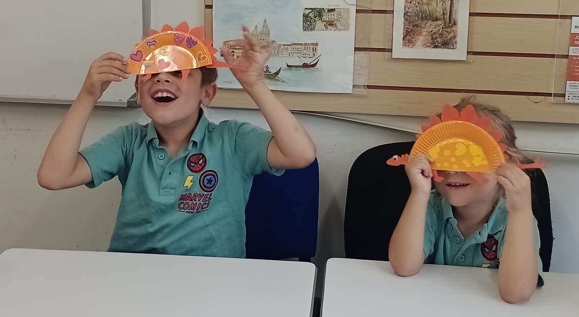 Children making dinosaurs - covered faces